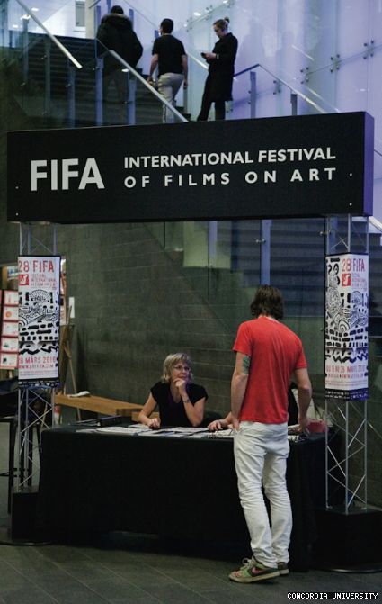 FIFA volunteer Dominique Paquette distributes information about the festival’s programming in the basement of the EV Complex.